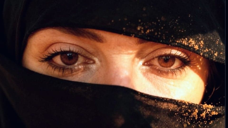 Close-up of a woman's eyes above a niqab